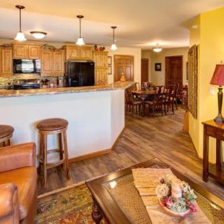 A cozy home interior featuring an open floor plan with a living room, kitchen, and dining area.