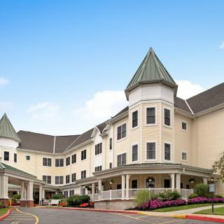 A castle-like hotel building with a unique architectural design set against a clear blue sky.