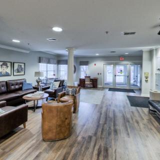 A modern lobby area featuring comfortable seating and wooden flooring.