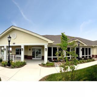 A residential building with a landscaped pathway on a sunny day.