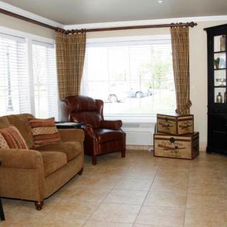 A cozy living room with comfortable seating and large windows.