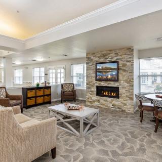A modern and cozy living room with a fireplace and comfortable seating.