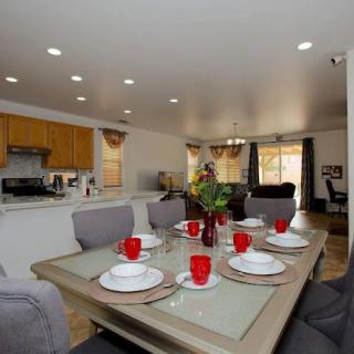 A modern open-plan kitchen and dining area with a beautifully set table.