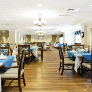 A spacious and elegantly decorated dining area with tables set for service.