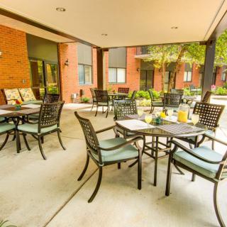 An inviting outdoor patio with tables and chairs set for a pleasant dining experience.