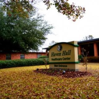 A healthcare center surrounded by autumn leaves and trees.