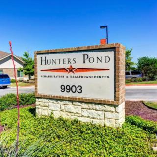 Entrance sign for Hunters Pond Apartments and Townhomes at 9903.