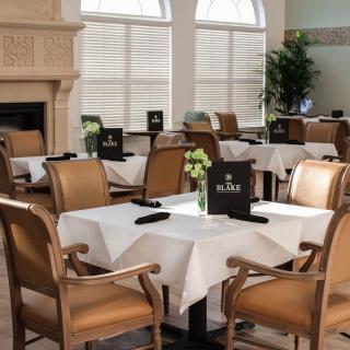 An elegant dining room with neatly arranged tables and chairs.