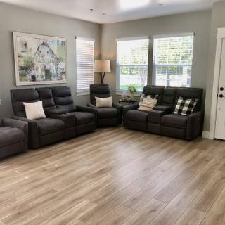 A cozy living room with comfortable seating and large windows.