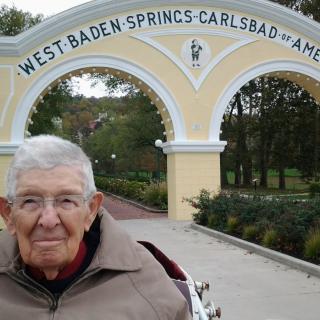 An elderly man in front of the West Baden Springs archway.