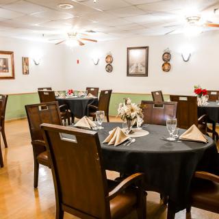 Elegant dining room with neatly arranged tables and chairs.