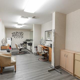 A modern hair salon interior featuring styling chairs, mirrors, and contemporary decor.