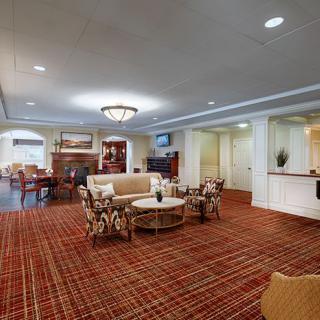 A spacious hotel lobby with elegant furnishings and a warm atmosphere.