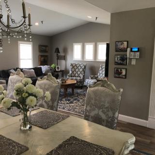 A cozy living and dining area with elegant decor and a chandelier.