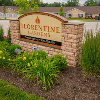 The welcoming sign of Florentine Gardens, surrounded by vibrant landscaping.