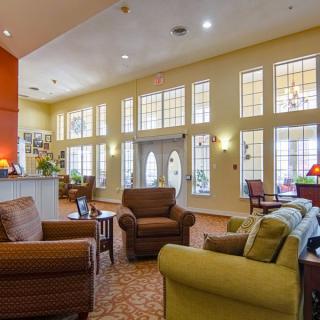 A cozy hotel lobby with comfortable seating and large windows.