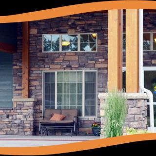 Front view of a house with a brick exterior and a cozy porch.