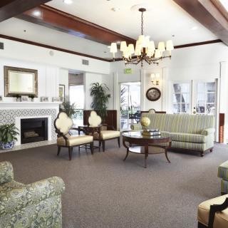 A spacious living room with elegant furniture and a chandelier.