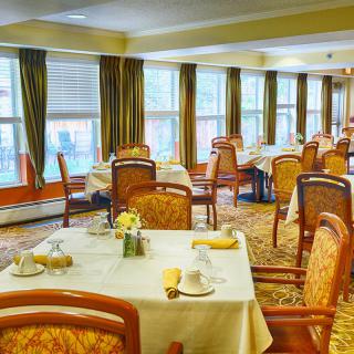Elegant dining room with neatly arranged tables and chairs.