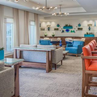 A modern living room with colorful seating and decorative accents.