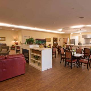A cozy open-concept living room and dining area with comfortable seating and warm lighting.