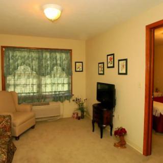 Cozy living room with a TV and seating area.