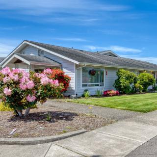 A suburban house with a well-maintained garden and lawn.