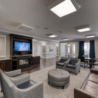 A modern living room with comfortable seating, a television, and stylish decor.