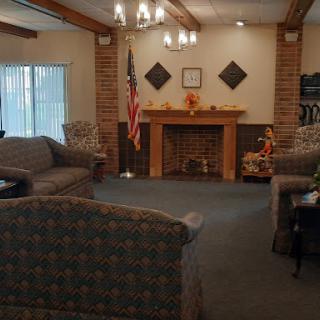 A cozy living room featuring comfortable sofas, a fireplace, and warm decor.