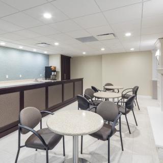 A modern cafe interior with tables, chairs, and a counter.
