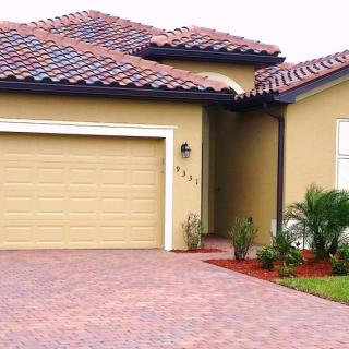 A suburban house with a tiled roof and a spacious driveway.