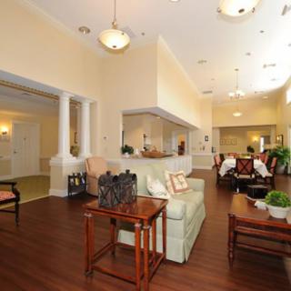 A cozy and well-designed living room with a sofa, coffee table, and elegant lighting.