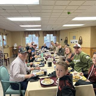 A lively gathering of friends and family enjoying a meal together.