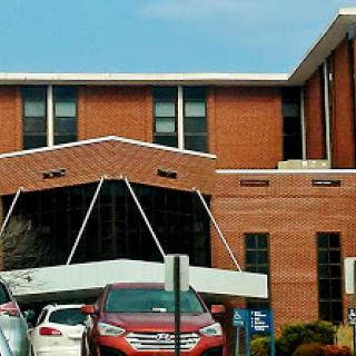 Entrance of a healthcare facility showcasing modern architectural design.