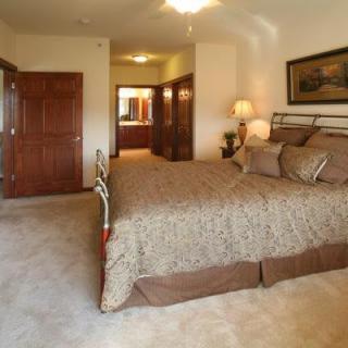 A spacious bedroom with a large bed and elegant decor.