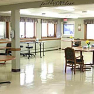 A clean dining area with tables and chairs in a well-lit room.