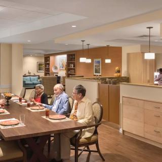 A group of seniors enjoying a meal together in a casual dining setting.