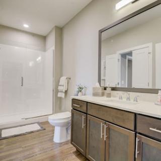 A modern bathroom featuring a spacious shower, elegant vanity, and tasteful decor.