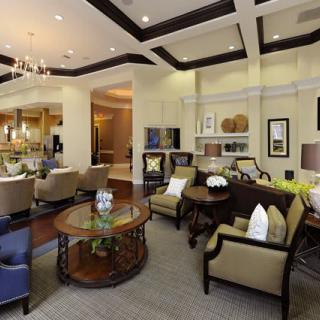 A spacious and elegantly designed living room with comfortable seating, stylish furniture, and ambient lighting.