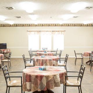 A spacious dining area with neatly arranged tables and chairs, designed for communal meals and gatherings.