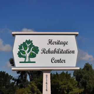 Sign for Heritage Rehabilitation Center with tree logo.