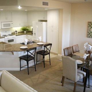 A modern open floor plan featuring a kitchen with counter seating and an adjoining dining area.