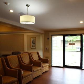 A cozy waiting area with comfortable seating and natural light entering through the glass door.