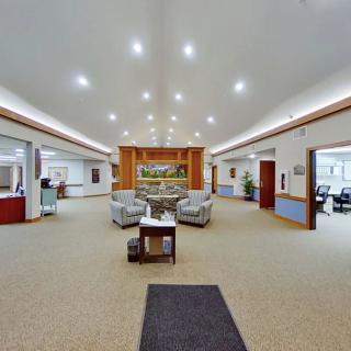 A spacious lobby with modern lighting and comfortable seating arrangements.
