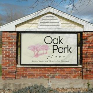 A brick sign displaying 'Oak Park Place' outdoors.