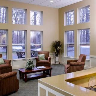 A cozy lobby area with comfortable seating and large windows.