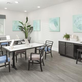 A modern meeting room with stylish furniture and abstract artwork on the walls.