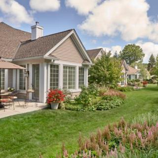 A beautiful residential house with a well-maintained garden and patio.