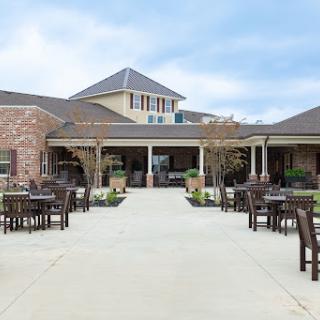 A welcoming outdoor patio area surrounded by a beautifully designed residential building.