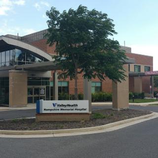 Exterior view of a modern medical facility with clear signage.